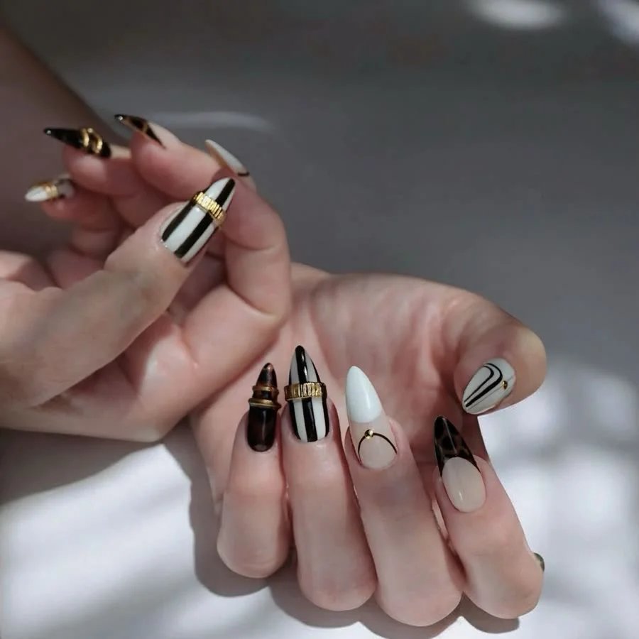Black, white and gold striped nail art